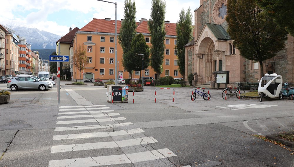 Der Platz zwischen Pfarrkirche und Pradler Straße vor der Sanierung: Die Blumentröge aus Beton werden entfernt, der Platz wird begrünt.