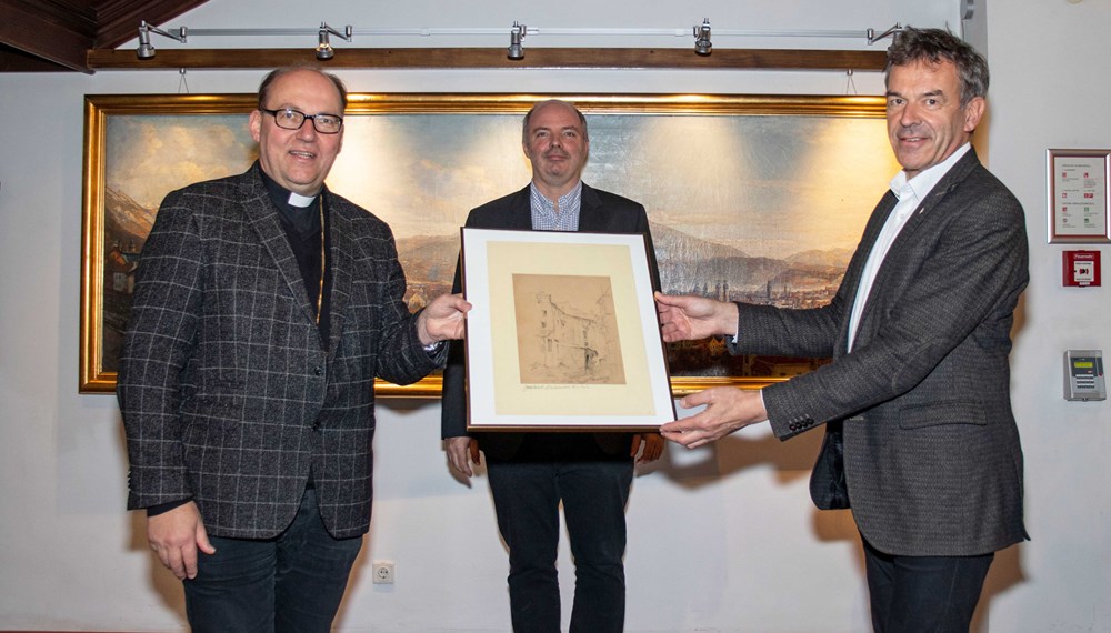 Ein besonderes Geschenk erhielt Bürgermeister Georg Willi (r.) von Bischof Hermann Glettler (l.): Eine Zeichnung des Innsbrucker Künstlers Wilhelm Nicolaus Prachensky (1898-1956). Der Bürgermeister gab das Werk an das Stadtarchiv/Stadtmuseum Innsbruck unter der Leitung von Lukas Morscher (M.) weiter. Es zeigt die Zerstörung der Innsbrucker Altstadt durch den Zweiten Weltkrieg. Während der Dom zu St. Jakob schwer getroffen wurde, blieb der Großteil der Wahrzeichen wie das Goldene Dachl, der Stadtturm, die Hofburg, das Helblinghaus oder die Ottoburg weitgehend von Bombenschäden verschont.