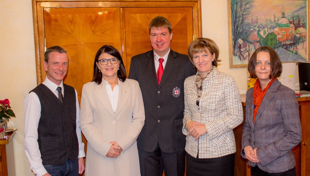 Im April dieses Jahres wurde der neue Vorstand des Roten Kreuzes Innsbruck gewählt. Nur wenig später konnte auch die neue Geschäftsführerin Alexandra Tanda gefunden werden. Jetzt präsentierte Obmann Rupert Mayrhofer die sozialen Ziele des Vereines der Innsbrucker Bürgermeisterin.
„Es ist sicherlich eine der angenehmsten Aufgaben, die ich als Obmann erhalten habe“, so Rupert Mayrhofer nach seinem Besuch, den er am 1. Dezember gemeinsam mit Geschäftsführerin Alexandra Tanda bei Bürgermeisterin Oppitz Plörer absolvierte. In diesem Besuch ging es inhaltlich einerseits um die Vorstellung der neuen Geschäftsführerin Alexandra Tanda. Die 54-jährige Mutter einer Tochter kam bereits 2014 zum Roten Kreuz nach Innsbruck. „Ursprünglich lagen meine Aufgaben im Controlling, vor einigen Wochen übernahm ich die Geschäftsführung. Unser Mission Statement lautet: Das Los der Menschen in Not und sozial Schwacher durch die Kraft der Menschlichkeit zu verbessern. Diese Kraft der Menschlichkeit braucht aber eine stabile wirtschaftliche Basis, für die ich mich gerne verantwortlich mache“, stellt sich die neue Geschäftsführerin vor.
„Mich freut es besonders, dass es uns gelungen ist, Frau Bürgermeisterin Oppitz-Plörer als Schirmherrin für unseren im Juli 2017 stattfindenden Landesjugendbewerb zu gewinnen“, erzählt der Obmann vom Besuch: „Viele unserer Hilfsangebote sind auch für die Stadt Innsbruck wertvoll und die Freiwillige Rettung Innsbruck steht ihrerseits für eine gute Partnerschaft mit der Stadt Innsbruck gerne zur Verfügung. Die Winternotschlafstelle, der Hausnotruf, die Jugendarbeit, der Besuchsdienst für alleinstehende Senioren, unsere vielen Ersthelferkurse oder die Arbeit für die Menschen auf der Flucht, die weiterhin entlang unserer sieben Grundsätze erbracht wird.“
v.l.: Vizebürgermeister Christoph Kaufmann, Geschäftsführerin Alexandra Tanda, Obmann Rupert Mayrhofer, Bürgermeisterin Christine Oppitz-Plörer, Vizebürgermeisterin Sonja Pitscheider